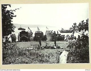 KALAI PLANTATION, NEW BRITAIN. 1945-02-21. A BUSY SCENE AT THE KALAO PLANTATION BEACHHEAD OF HEADQUARTERS, 6TH INFANTRY BRIGADE