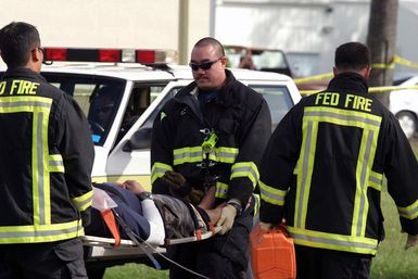 Federal Fire Department Firefighter's Asato and Ching carry U.S. Navy Boatswain's Mate Second Class Art on a litter during training at the Marine Corps Base Hawaii Post Exchange parking lot on Dec. 9, 2004.(U.S. Marine Corps official photo by CPL. Nicholas Riddle) (Released)