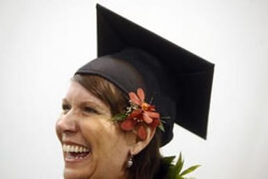 Claudia Janiszewski (cq), laughs with fellow school-mates before the commencement of their graduation ceremony at the Denver Convention Center. Claudia, an American woman born in Hawaii, graduated from Metro State University from her special degree, Non-P