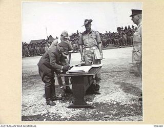 CAPE WOM, NEW GUINEA, 1945-09-13. LIEUTENANT-GENERAL H. ADACHI, COMMANDER 18 JAPANESE ARMY IN NEW GUINEA, SIGNING THE INSTRUMENT OF SURRENDER. HE ACCEPTED THE TERMS UNCONDITIONALLY. ..