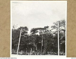 ELA BEACH, NEW GUINEA. 1944-01-01. CORPORAL J. FREENEY, 59TH UNITED STATES PORT BATTALION WINNING THE HIGH JUMP AT THE ALLIED SERVICES GRAND SPORTS CARNIVAL WITH A JUMP OF 5' 7"