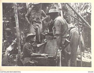 CHABAI/SORAKEN AREA, BOUGAINVILLE, 1945-06-16. BRIG J.R. STEVENSON, COMMANDER 11 INFANTRY BRIGADE (3), INSPECTING A TYPE 89 JAPANESE TANK FOUND BY C COMPANY, 26 INFANTRY BATTALION (AIF). IDENTIFIED ..