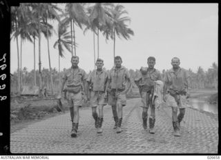 MILNE BAY, PAPUA. 1942-09. PILOTS OF NO. 75 FIGHTER SQUADRON RAAF GOING OUT ON A STRAFING RAID. LEFT TO RIGHT:- FLYING OFFICER B. D. WATSON, SERGEANT NORMAN, SERGEANT R. G. RIDDELL, ..