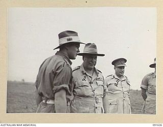 NADZAB, NEW GUINEA. 1945-05-11. GENERAL SIR THOMAS A. BLAMEY, COMMANDER-IN-CHIEF, ALLIED LAND FORCES, SOUTH WEST PACIFIC AREA (2), AND SENIOR OFFICERS WATCHING NATIVE RECRUITS OF THE PACIFIC ..