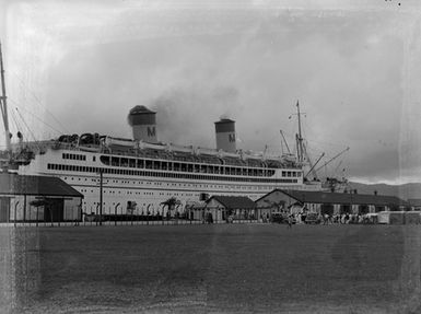 [A passenger liner from the Matson Line moored, in foreground sports field]