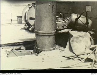 MILNE BAY. C.1943-04-14. DAMAGE TO THE FORECASTLE DECK ABAFT THE 12 POUNDER GUN OF HMAS PIRIE. IT WAS CAUSED BY A BOMB HIT FROM A JAPANESE AIRCRAFT WHEN THE CORVETTE WAS ATTACKED OFF ORO BAY, NEW ..