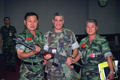 Lieutenant General Kim Myung Kwan, (left), Commandant of the Republic of Korean Marine Corps, Lieutenant General Frank Libutti, Commanding General, Marine Forces Pacific, Camp Smith, Hawaii, and Brigadier General Hahn, (right), CHIEF of STAFF of the Republic of Korean Marine Corps, pose with an M1918A2 BAR (Browning Automatic Rifle) Marine Forces Pacific presented to the Republic of Korea Marine Corps museum during Exercise ULCHI FOCUS LENS 2000. "ULCHI FOCUS LENS, held since 1976, is a computer-simulated, command-post exercise held to evaluate and improve operations in the defense of South Korea. There is no field training."