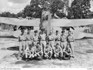 VIVIGANI, GOODENOUGH ISLAND, PAPUA. 1944-01-18. AN INFORMAL GROUP PORTRAIT OF WEST AUSTRALIANS WITH NO. 6 (BEAUFORT) SQUADRON RAAF WHICH FIGURED PROMINENTLY IN THE "BASHES" ON RABAUL. STANDING ..