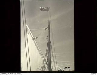PORT MORESBY, PAPUA. C. 1944. THE RAAF ENSIGN ON THE MAST OF A SAILING VESSEL USED BY THE RAAF RESCUE SERVICE