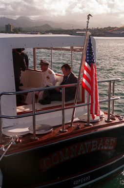 President George Bush sits with ADM Charles R. Larson, commander in chief, U.S. Pacific Command, aboard the admiral's barge as it departs from the USS ARIZONA MEMORIAL following an observance commemorating the 50th anniversary of the Japanese attack on Pearl Harbor