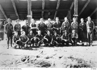 Madang, New Guinea. 1944-06-14. Group portrait of members of the 266th Light Aid Detachment, Headquarters 15th Infantry Brigade, outside the welding and blacksmith's workshop. The unit is located ..