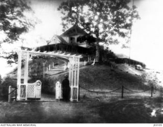 GERMAN GOVERNMENT HOUSE, RABAUL, UNDER OCCUPATION BY THE AUSTRALIAN NAVY AND MILITARY EXPEDITIONARY FORCE (AN&MEF). AN AUSTRALIAN SENTRY CAN BE SEEN AT THE GATE. 1914-10. (DONATED BY MR. W.H. ..