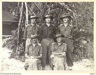 GREEN ISLAND, BOUGAINVILLE AREA, SOLOMON ISLANDS. 1944-12-19. LIEUTENANT COLONEL W M IRWIN, COMMANDING OFFICER, HQ 17 FIELD AMBULANCE, (1), WITH HIS OFFICERS AT THEIR LINES, THE REMAINDER OF THE ..