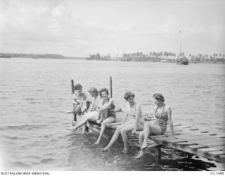 MADANG, NEW GUINEA. C. 1944-10. NURSING SISTERS OF A RAAF MEDICAL RECEIVING STATION AT A FORWARD AREA BASE IN NEW GUINEA ENJOY A WELL-EARNED DIP IN THE COOL WATERS OF THE PACIFIC. THE BATHING ..