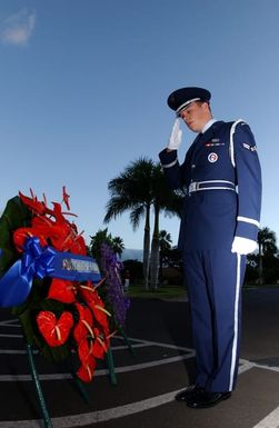 U.S. Air Force Hickam Honor Guard AIRMAN First Class Kevin Kriener, salutes a wreath during the 63rd anniversary of the attack on Hickam Field, at Hickam Air Force Base, Hawaii, on Dec. 7, 2004. (U.S. Air Force PHOTO by Mysti Bicoy, CIV.) (Released)