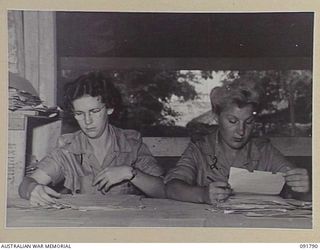 LAE, NEW GUINEA. 1945-05-15. PRIVATE D. DAY (1), AND PRIVATE D. BANNISTER (2), WORKING FOR THE ASSISTANT MILITARY SECRETARY, HEADQUARTERS FIRST ARMY, SORTING OFFICERS' FIELD RETURNS. A FEW DAYS ..