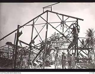 NAURU ISLAND. 1945-09-14. PERSONNEL OF THE 31/51ST INFANTRY BATTALION EXAMINING A WRECKED AND BURNT OUT MACHINE SHOP NEAR THE CENTRE OF THE TOWN