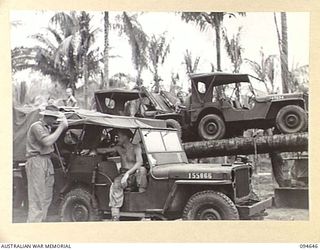 TOL, NEW BRITAIN, 1945-08-01. MEMBERS OF 52 TRANSPORT PLATOON, AUSTRALIAN ARMY SERVICE CORPS, WORKING ON THE MAINTENANCE OF JEEPS AT THEIR CAMP