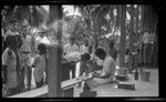 Malakai Veisamasama and Ni-Vanuatu man look through microscope