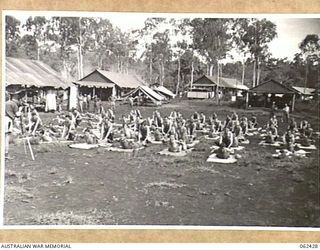 THORPVILLE, NEW GUINEA. 1943-12-07. POSTURE CASE PATIENTS DOING CORRECTIVE EXERCISES AT THE 113TH AUSTRALIAN CONVALESCENT DEPOT UNDER THE TUITION OF NX114481 SERGEANT J. B. CRAIG (1)