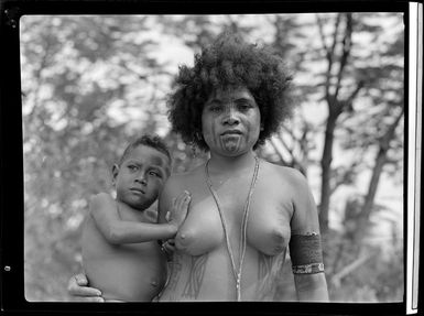 Native women carrying a kid, Port Moresby, Papua New Guinea