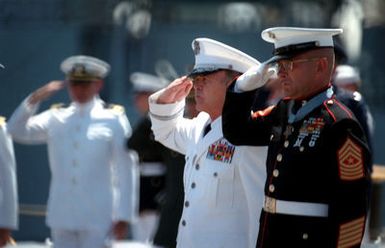 Marine Sergeant Major Allan J. Kellogg, right, Medal of Honor recipient for duty in Vietnam, and Air Force General Jerome F. O'Malley, commander-in-chief of Pacific Air Forces, salute during a ceremony to honor the Unknown Serviceman of the Vietnam Era. The serviceman's casket will be transported to California aboard the frigate USS BREWTON (FF 1086)