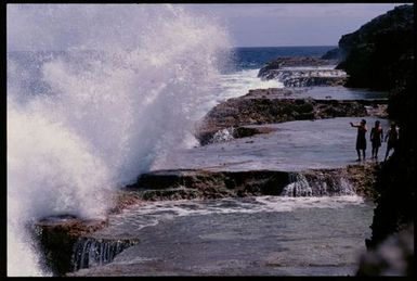 Waves crashing against rocky terrace, Niue