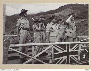 NEAR NADZAB, NEW GUINEA. 1945-03-26. LORD WAKEHURST, GOVERNOR OF NEW SOUTH WALES (7), TAKES THE SALUTE DURING THE MARCH PAST OF 2 NEW GUINEA INFANTRY BATTALION AT CAMP DIDDY. IDENTIFIED PERSONNEL ..