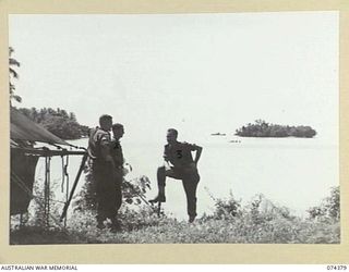 SIAR, NEW GUINEA. 1944-06-27. A SECTION OF THE COASTLINE VIEWED FROM THE AMENITIES HUT AT HEADQUARTERS, 15TH INFANTRY BRIGADE. IDENTIFIED PERSONNEL ARE:- VX111856 SERGEANT I.W. ROPER, AMENITIES ..