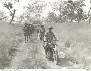 PORT MORESBY, PAPUA. 1942-07-11. AUSTRALIAN INFANTRY MARCHING ALONG BUSH TRACKS AS THEY MOVE UP TO "ATTACK" DURING MANOEUVRES CARRIED OUT UNDER THE DIRECTION OF AN A.I.F. COMMANDER FROM THE MIDDLE ..