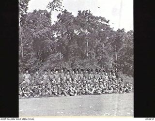 Outdoors group portrait of fifty seven personnel  of the 2/8th Commando Squadron. Identified, back row, left to right: Trooper (Tpr) S R Tindale (43); Tpr R W Henderson (44); Tpr A S Ford (45); Tpr ..