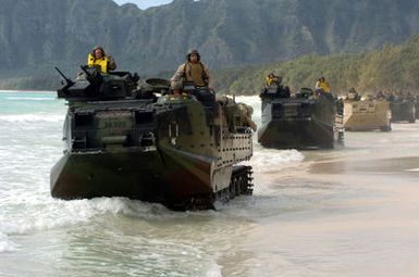 US Marine Corps (USMC) AAV7A1 Amphibious Assault Vehicles assigned to the 3rd Amphibious Assault Battalion maneuver along the beach at Training Area Bellows, Hawaii (HI), while conducting infantry and amphibious training