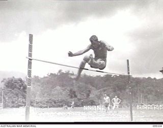 TOROKINA, BOUGAINVILLE, 1945-12-05. LEADING AIRCRAFTMAN PIKE, 390 BATH UNIT RAAF CLEARING THE BAR IN THE HIGH JUMP EVENT AT THE 3 DIVISION AMENITIES ATHLETIC CARNIVAL HELD AT GLOUCESTER OVAL
