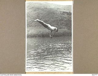 KUBA LAKE, RAMU VALLEY, NEW GUINEA. 1943-12-25. VX66633 PRIVATE N. COBBY COMPETING IN THE DIVING CONTEST AT THE CHRISTMAS CARNIVAL AND REGATTA ORGANISED BY MEMBERS OF THE 2/14TH INFANTRY BATTALION, ..