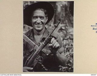 WONGINARA MISSION, NEW GUINEA. 1945-04-06. WARRANT OFFICER I W.R. EDMONSTON, 2/3 INFANTRY BATTALION (1), WHO WATCHED A JAPANESE SNIPER CLIMB INTO A TREE AND THEN SHOT HIM OUT OF IT