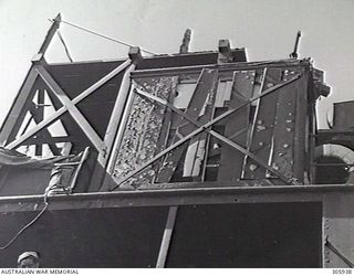 PORT HERVEY, PAPUA. 1943-05-09. BOMB DAMAGE TO THE WIRELESS CABIN OF THE MERCHANT VESSEL NOORA, DAMAGED BY JAPANESE AIR ATTACK. (NAVAL HISTORICAL COLLECTION)