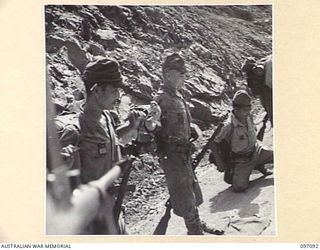 MOUNT SHIBURANGU, WEWAK AREA, NEW GUINEA. 1945-09-21. TROOPS OF 18 JAPANESE ARMY BEING SEARCHED AT A CONTROLLING POINT AT MAKOW ON TOP OF MOUNT SHIBURANGU. THE CONTROL POINT WAS ESTABLISHED BY ..