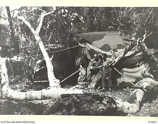 DALLMAN RIVER, NEW GUINEA, 1944-02-25. VX137733 CRAFTSMAN J. GROWER (1) WITH V306983 CORPORAL G.F. TAYLOR AND VX74469 STAFF SERGEANT E.F. LEWIS, MEMBERS OF THE 231ST LIGHT AID DETACHMENT ATTACHED ..