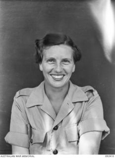 LAE, NEW GUINEA, 1945-05. WARRANT OFFICER 2 L.M. CAREY, AWAS BARRACKS. SHE IS STATIONED AT THE HEADQUARTERS OF THE ASSISTANT DIRECTOR OF CANTEENS SERVICE AND ARRIVED WITH THE FIRST LARGE DRAFT OF ..