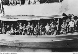 PORT MORESBY, NEW GUINEA. 1942-04-12. SERVICE PERSONNEL OF THE RABAUL GARRISON AND CIVILIANS FROM NEW BRITAIN CROWD THE RAILS OF THE HMAS "LAURABADA" AS THE SHIP DRAWS INTO THE WHARF. THE EVACUEES, ..