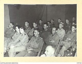 BOSLEY FIELD, BOUGAINVILLE, SOLOMON ISLANDS. 1945-03-15. AN AUDIENCE WATCHING THE AMATEUR PROGRAMME "STARS IN UNIFORM" CONDUCTED BY THE AUSTRALIAN ARMY BROADCASTING STATION