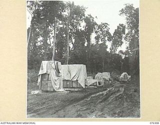 LAE, NEW GUINEA. 1944-09-27. STORES, COVERED WITH CANVAS, OUT IN THE OPEN AT THE 43RD FIELD ORDNANCE DEPOT