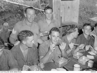 RABAUL, NEW BRITAIN, 1945-12-25. MEMBERS OF 37/52ND INFANTRY BATTALION ENJOYING THEIR CHRISTMAS DINNER