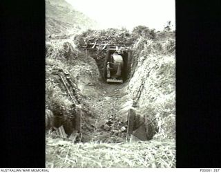 NEW BRITAIN, 1945-09. A JAPANESE SEARCHLIGHT AT THE ENTRANCE TO ITS BUNKER IN THE RABAUL AREA. (RNZAF OFFICIAL PHOTOGRAPH.)