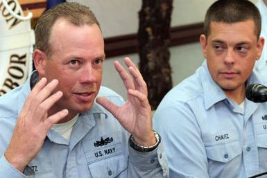 US Navy (USN) Hull Maintenance Technician First Class (HT1) Martin Mantz (left), and USN Hull Maintenance Technician Second Class (HT2) Gary Chavez talk to reporters at a press conference about their rescue after floating overnight 21 miles off the island of Oahu, Hawaii (HI), when their 21-foot fishing boat sank on October 24th. During the night, the two Sailors became separated but a US Coast Guard (USCG) HH-65 Dolphin helicopter crew located and pulled USN HT2 Chavez from the water. USN HT1 Mantz rescued the next day by the Good Samaritan fishing vessel NANI G. Both Sailors are instructors assigned to the Center for Naval Engineering Learning Site, Pearl Harbor, HI