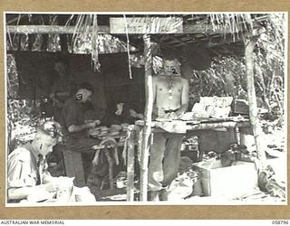 DUMPU, NEW GUINEA, 1943-10-10. AT HEADQUARTERS FIELD POST OFFICE, LEFT TO RIGHT, WX4051 CORPORAL S.E. JONES OF THE 2/16TH AUSTRALIAN INFANTRY BATTALION, VX8327 PRIVATE S. STEWART, VX20761 CORPORAL ..