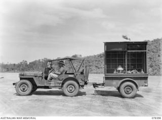 TOROKINA, BOUGAINVILLE ISLAND. 1945-01-20. SX35393 LANCE SERGEANT V. BLANDIN, 7TH PIGEON SECTION "B" CORPS OF SIGNALS, USING A MOBILE LOFT TO TRAIN YOUNG MESSAGE CARRYING PIGEONS