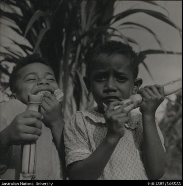 Children eating sugar cane