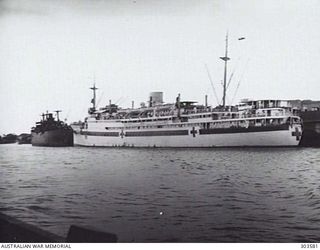 PORT QUARTER VIEW OF THE 2/1 AUSTRALIAN HOSPITAL SHIP MANUNDA WHICH WAS BOMBED AND HEAVILY DAMAGED IN DARWIN HARBOUR BY JAPANESE AIRCRAFT ON 1942-02-19. ON THE NIGHT OF 1942-09-06 SHE WAS LYING ..