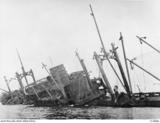 1943-05-19. NEW GUINEA. GONA. THIS WRECKED JAPANESE SHIP "AYATOSAN MARU", SUNK BY ALLIED AIRCRAFT DURING THE BATTLE OF GONA. IT IS NOW USED FOR TARGET PRACTICE BY ALLIED FORCES AT GONA BEACH. ..